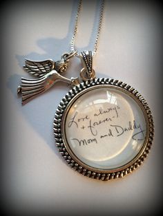 a necklace with an angel on it that says, i am sorry mom and daddy