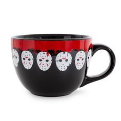 a coffee cup with five faces painted on it