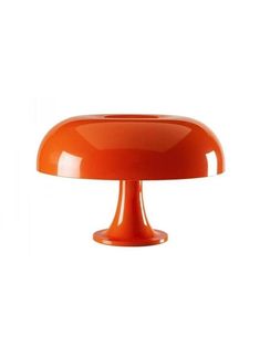 an orange table lamp on a white background