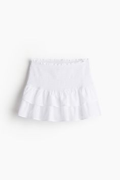 Fitted mini skirt in soft  woven cotton fabric. Ruffle-trimmed waistband with wide smocking. Gathered tiers above hem for volume and movement. Unlined. Cotton Tiered Skirt With Elastic Waistband, Summer Stretch Tiered Skort, Tiered Cotton Bottoms With Ruffles, Summer Tiered Skort With Elastic Waistband, Stretch Tiered Mini Skirt For Summer, Tiered Cotton Skirt With Lining, Spring Stretch Tiered Skirt, Spring Tiered Stretch Skirt, Casual White Skirt With Ruffle Hem