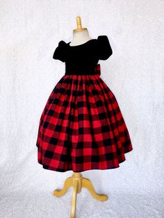 An elegant dress that's perfect for any occasion: wedding, christmas, birthday, or pageant! This dress is made out of a comfortable cotton plaid bottom and velvet top. The top comes with short sleeves and a zipper on the back. Attached to the waist are two strips of plaid fabric that can be used to tie together into a bow at the back for a comfortable and snug fit. The plaid skirt has a layer of layer of lining with crinoline attached to give the skirt some fullness. *Mannequin has petticoat to Elegant Winter Holiday Princess Dress, Fitted Red Princess Dress For Birthday, Red Fitted Princess Dress For Birthday, Fitted Festive Holiday Dress, Festive Fitted Holiday Dress, Fitted Princess Dress For Christmas Birthday, Fitted Winter Holiday Princess Dress, Fitted Holiday Dress For Festive Occasion, Fitted Princess Dress For Christmas Dress-up