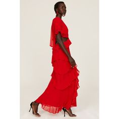 a woman wearing a red dress and high heels standing in front of a white background