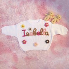 Here, we focus on creating custom and personalized baby/toddler/children's sweaters with a sense of artistic pride. Each sweater is adorned with a baby's name and hand embroidered with rough yarn on the chest. DESCRIPTION: Each sweater proves our meticulous craftsmanship, handmade and hand embroidered on high-quality, ultra soft 100% pure cotton oversized sweaters (carefully designed and crafted by us). Handembroidered baby sweaters are an excellent gift choice for baby showers, newborn/family photos, moon concept photos of babies, birthdays, baptisms, or special events. (If you want to give a personalized gift, a hand embroidered baby sweater is a perfect choice.) Each piece of work is a unique artwork, tailored specifically for you. And become more meaningful. DETAILS: ﹥Material: Cotton White Letter Embroidery Sweater For Winter, Customizable Cute Winter Sweater, Customizable Cute Crew Neck Sweater, Cute Customizable Crew Neck Sweater, Cute Customizable Winter Sweater, Cute White Embroidered Sweater, Personalized Pink Sweater For Winter, Personalized White Sweater For Winter, Personalized Pink Long Sleeve Sweater