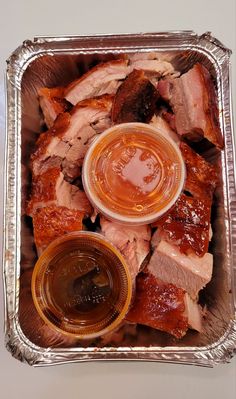 meat and sauces in a metal pan on a table