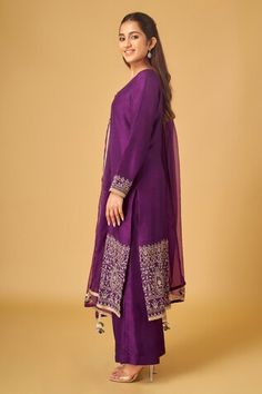 Purple full sleeves A-line kurta crafted in raw silk with bloom vine embroidery and sequin highlights. Paired with a flared pant and sequin spluttered organza dupatta with gota tassel embellishments. - Aza Fashions Long Sleeve Raw Silk Palazzo Set With Zari Work, Chanderi Long Sleeve Palazzo Set For Reception, Long Sleeve Chanderi Palazzo Set For Reception, Silk Sharara With Long Sleeves For Reception, Silk Palazzo Set For Reception With Long Sleeves, Embroidered Raw Silk Long Sleeve Palazzo Set, Raw Silk Long Sleeve Palazzo Set With Mirror Work, Long Sleeve Raw Silk Palazzo Set With Mirror Work, Silk Palazzo Set With Mirror Work And Long Sleeves