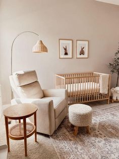 a baby's room with a crib, rocking chair and ottoman in it