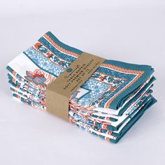 a stack of blue and white cloths with a brown tag on top of them