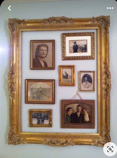 a wall with many framed pictures on it