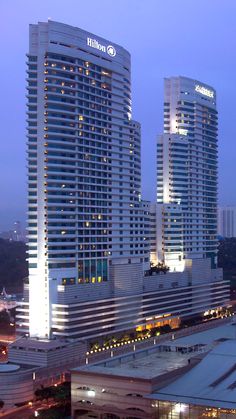 the hilton hotel and casino towers are lit up at night in this cityscape