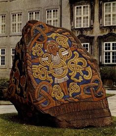 a large rock sitting in front of a building