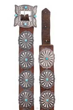 two belts with turquoise stones and silver buckles on each belt, one is made out of