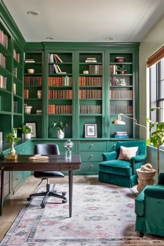 an office with green bookshelves and chairs in the corner, along with a rug on the floor