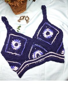 This blue sunflower crop top is best for festivals, birthday parties, and beachwear. This is a sleeveless crop top with a deep V-neck. The back of the dress contains a nice criss-cross pattern. This is a quality piece of crochet wear and 100% handmade in Sri Lanka. The top is crocheted with soft cotton wool yarns and gives a smooth feeling when you are wearing it. **Please double-check your measurements with the size chart displayed in the images section above, before you purchase the product as we do not refund or exchange. **There can be a slight color difference between the product and the displayed images due to lighting differences. Beachwear Cropped Crop Top For Beach Season, Summer Sleeveless Fitted Crop Top, Sleeveless Fitted Summer Crop Top, Sleeveless Fitted Crop Top For Summer, Summer Party Triangle Top, Sleeveless Crop Top For Beach Season Party, Multicolor Cropped Beachwear Crop Top, Sleeveless Cotton Crochet Top For Beach Season, Summer Party Tank Top