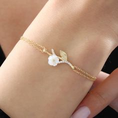 The magnolia-like flower on the bracelet is made of original mother-of-pearl stone. The mother-of-pearl stone represents power, grace and abundance. In addition, proximity to the mother-of-pearl stone has many benefits in energy. The two-stranded bracelet design that combines mother-of-pearl stone with the bracelet represents the journey of life and the elegance of women. It has a design that you will always carry with you in your daily life, on an important date, on the beach or at a great part Elegant White Promise Bracelet, Elegant Flower Shaped Jewelry For Promise, Dainty Flower Jewelry For Mother's Day, Elegant Flower-shaped Jewelry For Promise, Elegant Flower Shaped Promise Jewelry, Elegant Flower-shaped Promise Jewelry, Elegant Flower Bracelets For Anniversary, White Gold Flower Jewelry For Promise, Elegant White Bracelets For Mother's Day