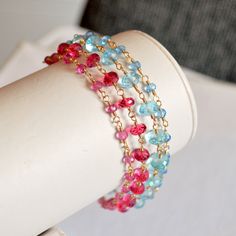 "This multistrand bracelet is pure luxury. I designed this piece with Summer brides in mind, but it is perfect for anyone who loves bright, tropical colours. Four strands of sparkly gemstones encircle your wrist in this lovely bracelet, which combines sky blue, rosy pink and hot pink stones. I used blue quartz beads in two sizes, and pink quartz beads in two sizes and shades. A bright blue quartz stone decorates the clasp. This is the perfect touch for an elegant Summer wedding, or just as a spe Multistrand Bracelet, Wedding Jewelry For Bride, Summer Bride, Armband Gold, Tropical Punch, Gemstone Beads Jewelry, Multi Strand Bracelet, Pink Topaz, Wedding Jewelry Bracelets