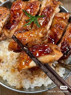 chicken and rice with chopsticks in a bowl