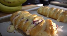 several pastries sitting on top of a baking pan next to some banana's