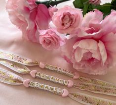 three pink flowers and some type of nameplates