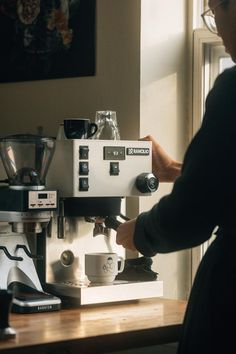 a person is working on a coffee machine