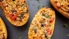 three stuffed squash halves filled with different types of food and garnished with parsley