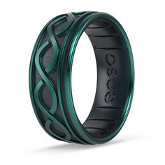 a black and green wedding band with an intricate design on the inside, in front of a white background