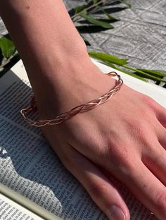 18-gauge 100% pure copper three piece dainty braided bangle bracelet.  Lightweight and comfortable design with delicate features. When exposed to the elements this metal shows colorful variations. Coppers thermal and electrical conductive qualities heighten your ability during spiritual practice of prayer and meditation. Due to this bracelet's delicate nature, be mindful not to bend. Bangle length is 9 inches. Comfortably fits up to 8 inch wrist Please keep in mind Copper naturally ages over time.  The patina of this piece will add to it's unique beauty! 🤎All of my jewelry is handmade and nonrefundable.  I encourage you to reach out with any questions if you are unsure about a piece! I am more than happy to answer and send additional pictures etc.  I cannot allow refunds due to a number o Bohemian Braided Bangle Jewelry, Adjustable Braided Bangle Jewelry, Rose Gold Bohemian Bracelets, Bohemian Rose Gold Wire Wrapped Bracelets, Elegant Rose Gold Braided Bracelet For Friendship, Adjustable Rose Gold Wire Wrapped Bracelets, Adjustable Rose Gold Braided Bracelets, Adjustable Rose Gold Braided Bracelet, Bohemian Hand Wrapped Rose Gold Bracelets