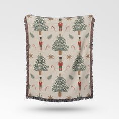 a blanket with christmas trees and nutcrackers on it