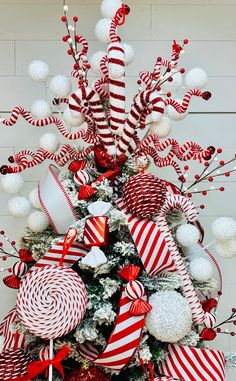 a christmas tree decorated with red and white candy canes