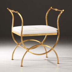 a golden chair with a white cushion on it