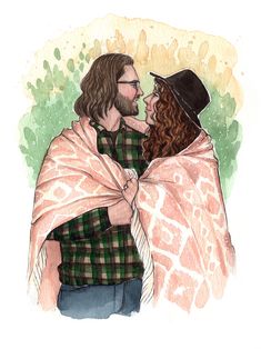 a man and woman wrapped in a blanket are looking at each other while standing next to each other