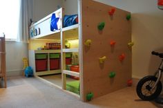 a child's bedroom with climbing walls and toys