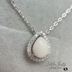 Elegant White Jewelry For Memorial, Delicate White Keepsake Jewelry, White Birthstone Necklace For Keepsake, White Delicate Keepsake Jewelry, Delicate White Necklace For Keepsake, White Pendant Necklace For Memorial, Elegant White Necklace For Memorials, White Gemstone Teardrop Pendant Necklace, White Teardrop Pendant Necklace With Gemstone