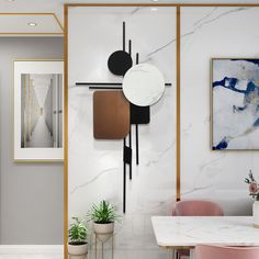 a white marble dining room with pink chairs and art on the wall behind it in an apartment