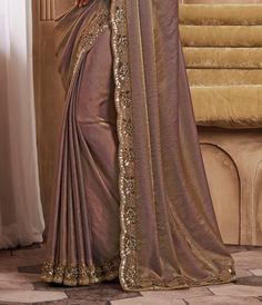 COLOR : Saddle Brown FABRIC : Saree - Fancy Silk, Blouse - Fancy Silk & Net WORK : Resham Embroidery, Stones, Sequins, Lace BorderOCCASION : Wedding, Engagement, Party Wear, Festival, Sangeet NOTE : The outfit includes blouse and saree only. Petticoat is not included. READY-TO-WEAR : No STITCHING : Available as semi-stitched fabric, can be stitched using standard size option (+$30). Note: There might be a slight color variation due to lighting and flash used during photoshoot. The bright shade seen is the best closer view of fabric's color. Fitted Satin Saree For Designer Wear, Embellished Raw Silk Saree With Traditional Drape, Satin Dupatta With Zari Work In Traditional Drape, Floor-length Saree With Intricate Embroidery In Chinon, Traditional Satin Sets With Zari Work, Eid Satin Blouse Piece With Zari Work, Intricate Embroidery Chinon Floor-length Saree, Floor-length Chinon Saree With Intricate Embroidery, Floor-length Intricate Embroidered Chinon Saree