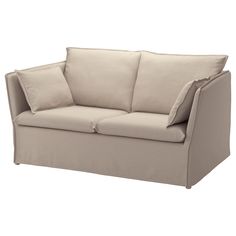 a beige couch with two pillows on it's back and one arm folded up