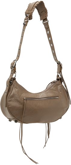 Crinkled Arena lambskin shoulder bag in taupe. · Adjustable shoulder strap · Detachable mirror at top · Studs and pin-buckle hardware at face · Gathering at face · Zip pocket at face and back face · Bumper studs at base · Zip closure · Zip pocket at interior · Plain-woven lining · H8 x W12.75 x D3.25 Supplier color: Dark mink grey Taupe Shoulder Bag With Palladium Hardware For Everyday, Evening Brown Hobo Bag With Palladium Hardware, Chic Brown Hobo Bag With Silver-tone Hardware, Brown Shoulder Bag With Gunmetal Hardware For Evening, Elegant Taupe Shoulder Bag With Silver-tone Hardware, Brown Hobo Bag With Metal Hardware For Evening, Evening Brown Hobo Bag With Metal Hardware, Designer Taupe Shoulder Bag With Gold-tone Hardware, Beige Hobo Bag With Silver-tone Hardware For Everyday Use