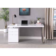 a white desk with two drawers and a laptop on it