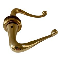 a brass colored hook on a white background