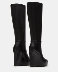 The AKIRA knee-high boot features a platform wedge design and a convenient inside zipper for easy on and off. Elevate your style game with this versatile and stylish boot, perfect for any occasion. 4.5 inch heel height Size 6 measurements: 14 inch shaft circumference, 13.75 inch shaft height Size 8 measurements: 15 inch shaft circumference, 14.75 inch shaft height Size 10 measurements: 16 inch shaft circumference, 15.75 inch shaft height Leather upper material Textile lining Synthetic sock Synth Fitted Polyurethane Platform Knee-high Boots, Fitted Faux Leather Knee-high Platform Boots, High Cut Faux Leather Heeled Boots, Fitted Polyurethane Platform Boots, Chic Knee-high Synthetic Platform Boots, High Heel Polyurethane Platform Boots With Zipper, Chic Platform Knee-high Faux Leather Boots, Chic Faux Leather Platform Knee-high Boots, Chic Knee-high Platform Boots In Faux Leather