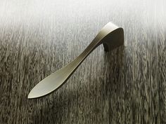 a metal object sitting on top of a wooden table