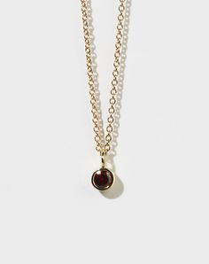 As we fall to earth from the dark and through the heavens. A fine chain featuring a round brilliant stone in an unfussy bezel setting. A celebration of harmony, simplicity, and the order of all things. The Heavens, Bezel Setting, Round Brilliant, Cosmos, Charm Necklace, Garnet, The Darkest, Solid Gold, Gold Plate