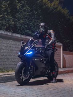 a man riding on the back of a black motorcycle