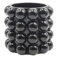 a black vase with many balls in it