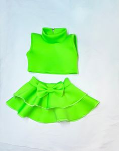 Neon green mock turtle neck crop top with double circle skirt pageant girls neoprene casual wear DUE TO THE NATURE OF THIS BEING A HANDMADE ITEM, NO REFUNDS OR EXCHANGES ON OUR ITEMS. PLEASE ENSURE YOU MEASURE YOUR CHILD FOR THE CORRECT FIT.  Get ready to fall in love with our captivating Toddler Neon Green Mock Turtle Neck Crop Top with Double Circle Skirt.  Crafted from soft neoprene fabric, this casual wear provides the perfect combination of comfort and style for your little pageant star.  T Green High Stretch Party Tops, Green Stretchy Party Sets, Green Stretch Party Sets, Green High Stretch Trendy Crop Top, Trendy High Stretch Green Crop Top, Trendy Green Fitted Sets, Trendy Fitted Green Sets, Trendy High-stretch Green Crop Top, Trendy Sleeveless Green Set