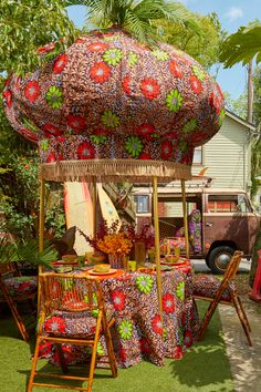 an outdoor area with chairs, table and umbrella