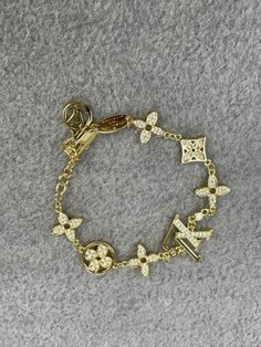 Vintage Louis Vuitton  Chain Bracelet Pristine Quality Assured. Ensuring Impeccable Condition For Every Item. Enjoy Rapid Shipping For Swift Delivery Size:18 Cm Luxury Women's Bracelets With Logo Charm, Luxury Gold Bracelets With Dangling Charms, Luxury Gold Bracelet With Dangling Charms, Lv Jewelry Bracelet, Luxury Yellow Gold Charm Bracelet Fine Jewelry, Luxury Gold Bracelets With Vintage Charm, Louis Vuitton Jewelry Bracelet, Luxury Elegant Bracelets With Vintage Charm, Luxury Vintage Bracelets For Anniversary