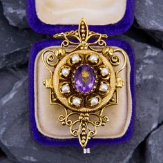 This elegant pin/pendant features one oval cut amethyst and eight cultured pearls. The piece is crafted of 14k yellow gold and fitted with a pendant bale and a pin back. We have added a 14k yellow gold 18 inch cable chain weighing approximately 2 grams with small jump rings so that it can also be worn at 16 and 17 inches. Heirloom Oval Brooch Jewelry, Elegant Gold Amethyst Brooches, Fine Jewelry Oval Brooch, Oval Purple Jewelry Brooch, Oval Purple Brooch Jewelry, Oval Fine Jewelry Brooch, Purple Oval Brooch Jewelry, Antique Oval Pearl Pendant Jewelry, Amethyst Brooch Jewelry For Anniversary