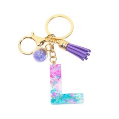 a keychain with the letter l on it and a tassell charm