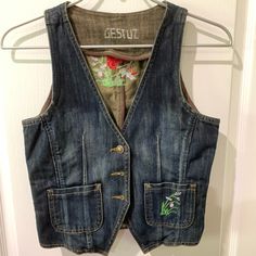 an old jean vest hanging on a hanger