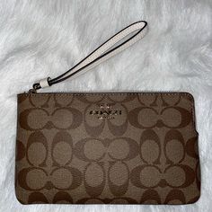 Nwt Coach Large Corner Zip Wristlet In Signature Canvas. Signature Coated Canvas And Smooth Leather Two Credit Card Slots Zip Closure, Fabric Lining Wrist Strap Attached 7 3/4" (L) X 4 3/4" (H) X 1/2" (W) Elegant Beige Clutch With Wrist Strap, Elegant Beige Coach Wristlet, Elegant Beige Clutch Wristlet, Elegant Brown Wristlet For Evening, Coach Evening Wristlet With Wrist Strap, Elegant Brown Evening Wristlet, Elegant Brown Clutch With Wrist Strap, Formal Brown Wristlet With Wrist Strap, Elegant Beige Rectangular Wristlet